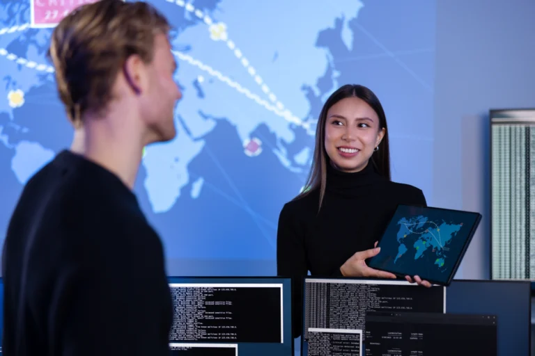 smiling-cyber-security-team-working-in-a-cyber-sec