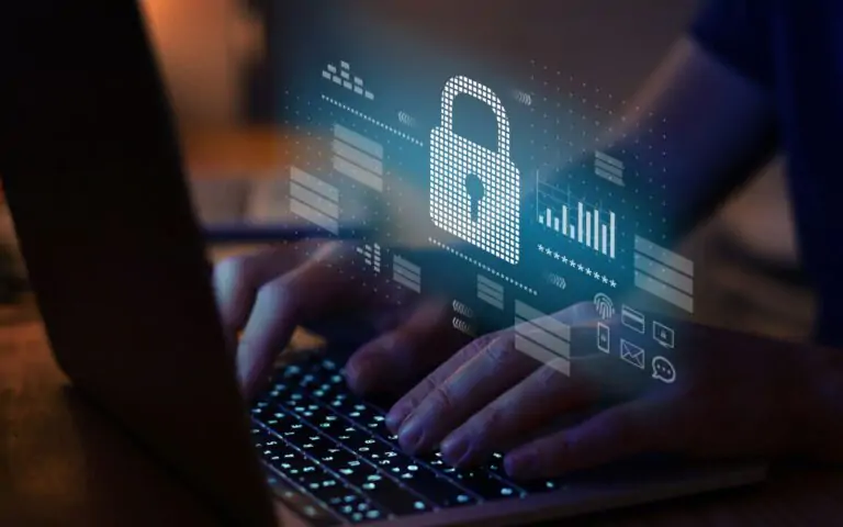 Cybersecurity image of hands typing on a laptop with a holographic lock icon and security data, symbolizing digital protection.